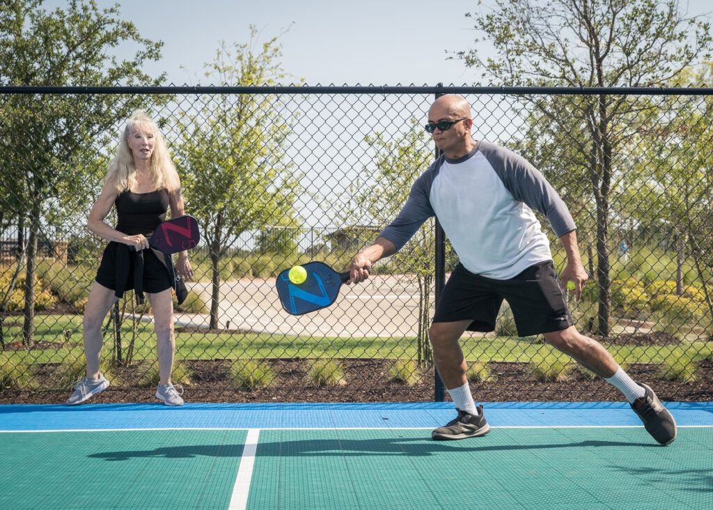 ladera texas active adult living - two active adults playing pickleball